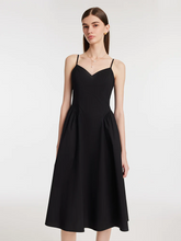 a lady in black gathered waist spaghetti strap midi dress
